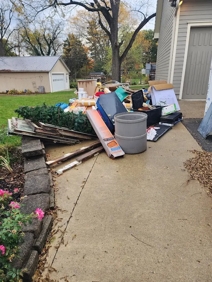 Dumpster being loaded with debris for 12 Yard Dumpster Rental in Waseca